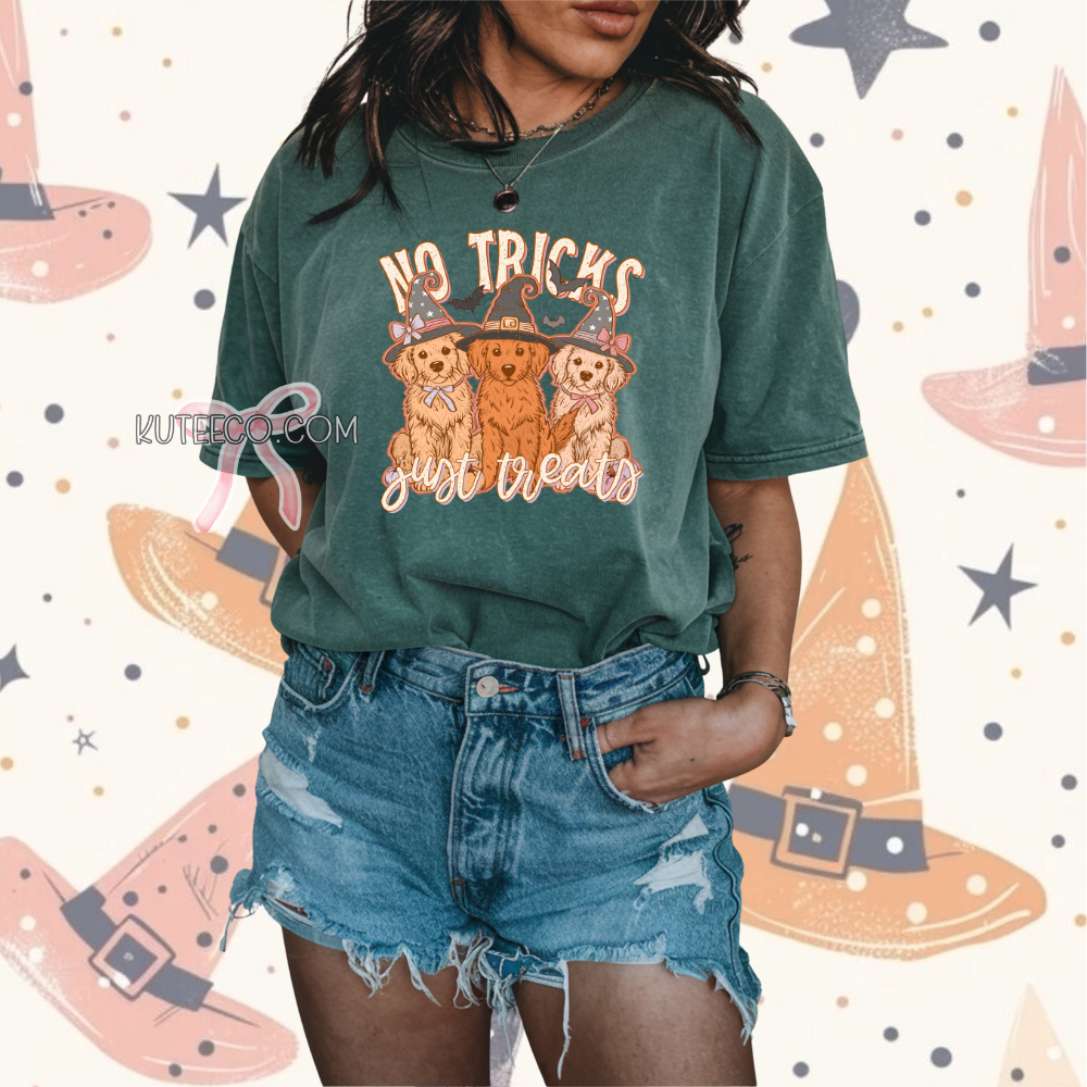 Person wearing a green t-shirt with 'No Tricks, Just Treats' and dog graphics on a colorful background.