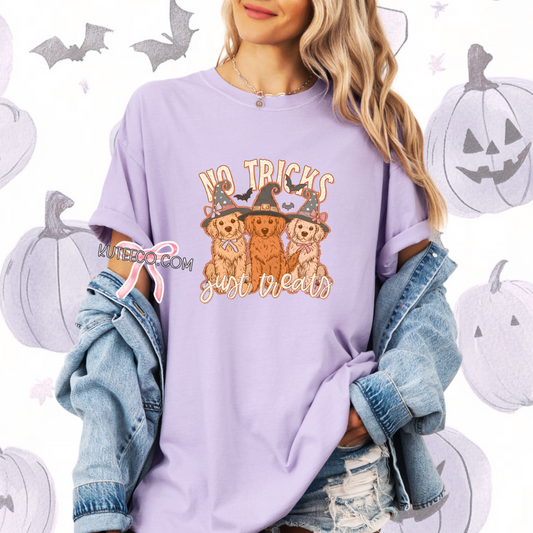 Person wearing a purple Halloween-themed shirt with cartoon dogs and text, surrounded by pumpkin and bat decorations.